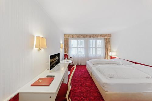 En eller flere senge i et værelse på Hotel Mozart