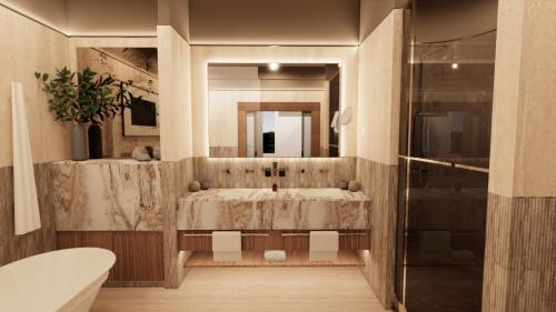 a bathroom with a tub and a sink and a mirror at Rockliffe in Darlington