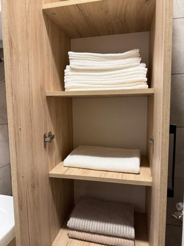 a shelf with folded towels in a bathroom at Golden LUX in Bar