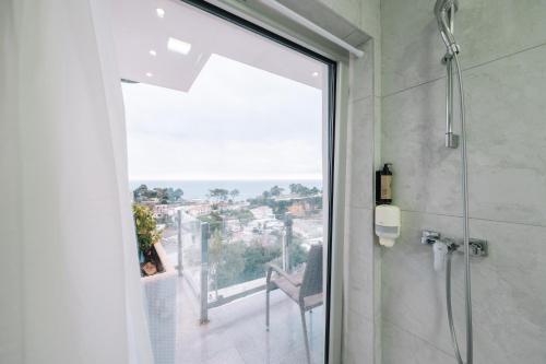 a bathroom with a glass shower door with a view at Senator Lux in Ulcinj