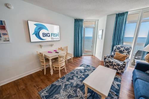 a living room with a table and chairs and a couch at Baywatch Renovated, Unobstructed Oceanfront Views in Myrtle Beach