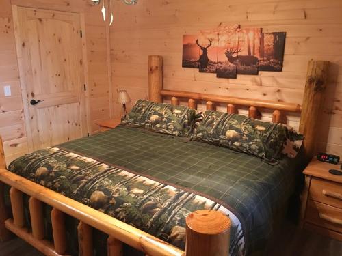 a bedroom with a bed in a log cabin at Little Elk Cabin in Banner Elk