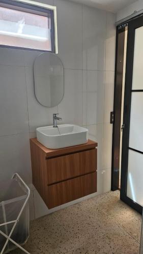 a bathroom with a sink and a mirror at Abagta Kosan in Jakarta