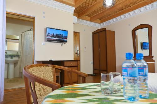 a table with two bottles of water on top of it at Hotel Fatima Boutique in Bukhara