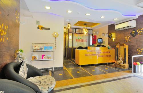 a restaurant with a yellow counter in a room at Hotel Persona International in New Delhi