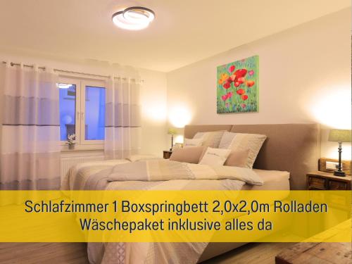 a bedroom with a bed and a painting on the wall at Ferienhaus Däschinger in Mastershausen
