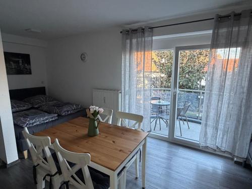 a living room with a table and chairs and a dining room at FeWo Hess in Rust