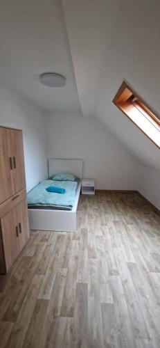 a bedroom with a bed and a wooden floor at Privatpension Dreger in Alzey