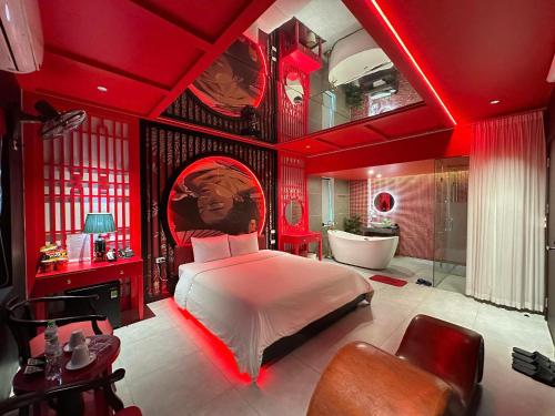 a red bedroom with a bed and a bath tub at Nhật Tân Hotel Vĩnh Ngọc II- Đông Anh in Dong Anh