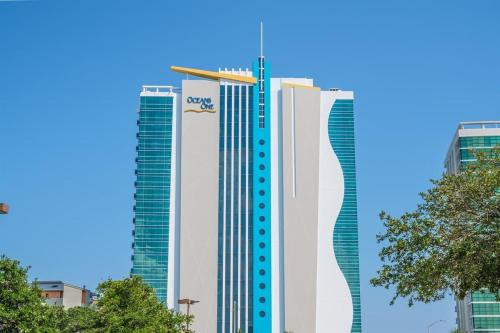 two tall buildings with a crane on top of them at New Corner Suite 2BR, Direct Ocean and City Views in Myrtle Beach