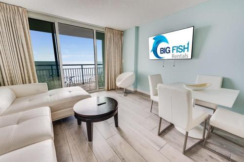 a living room with a couch and a table at Low Floor,Modern Building, Pools Direct Oceanfront in Myrtle Beach