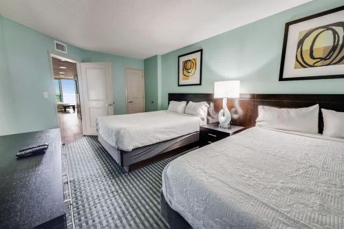 a hotel room with two beds and a room with two at Low Floor,Modern Building, Pools Direct Oceanfront in Myrtle Beach