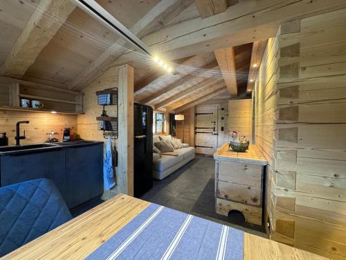a kitchen and living room in a tiny house at Chalet Flond in Obersaxen