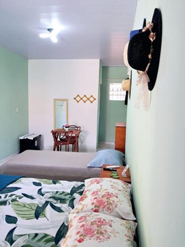 a bedroom with two beds and a table with a chair at Aguapé 4 in Barreirinhas