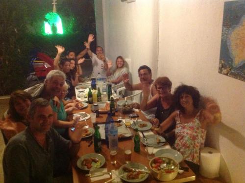 a group of people sitting around a table at Theoni Studios in Kastraki Naxou
