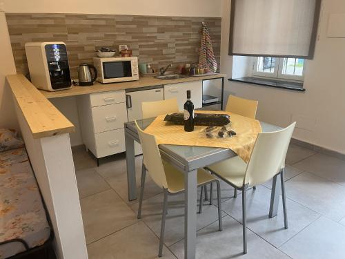 a kitchen with a table with a bottle of wine on it at La Gisina B&B in Gaglianico
