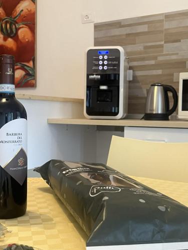 a bottle of wine sitting on a table next to a box at La Gisina B&B in Gaglianico