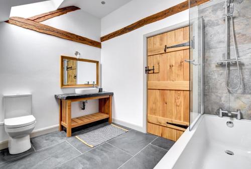 a bathroom with a shower and a toilet and a sink at 5 Bed in Machynlleth oc-bow30 in Darowen