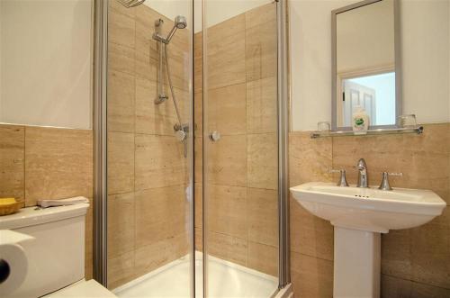 a bathroom with a shower and a sink and a toilet at 5 Bed in Torquay oc-rutlod in Torquay
