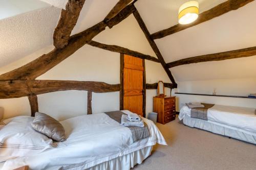 a bedroom with two beds and a tree at 3 Bed in Denbigh oc-waf147 in Gwaynynog
