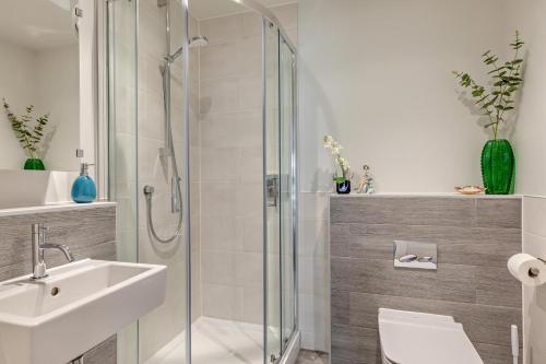 a bathroom with a shower and a sink and a toilet at 2 Bed in Woolacombe oc-m29811 in Woolacombe