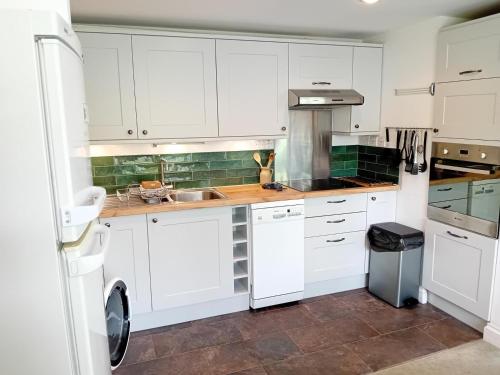 a kitchen with white cabinets and a sink at 2 Bed in St. Levan oc-p00788 in Saint Levan