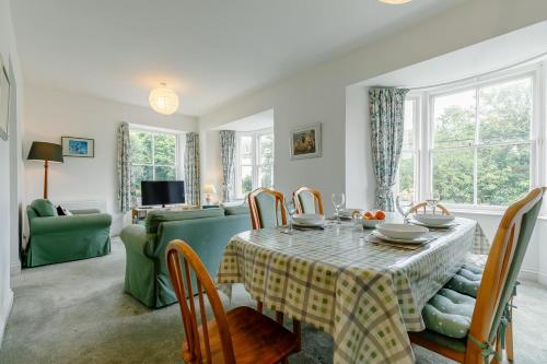 a dining room with a table and a green couch at 2 Bed in St. Levan oc-p00788 in Saint Levan