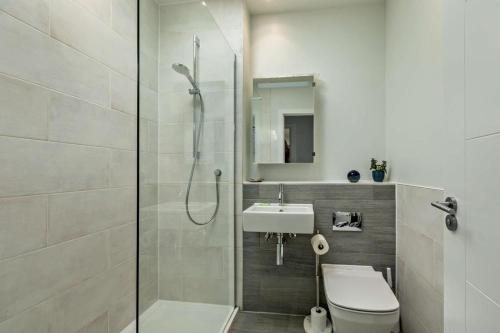 a bathroom with a shower and a toilet and a sink at 3 Bed in Woolacombe oc-s29615 in Woolacombe