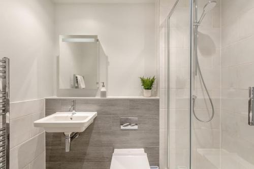 a white bathroom with a sink and a shower at 2 Bed in Woolacombe oc-c29617 in Woolacombe