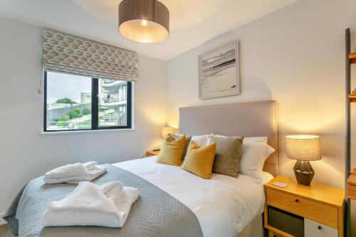 a bedroom with a white bed and a window at 2 Bed in Woolacombe oc-c29617 in Woolacombe