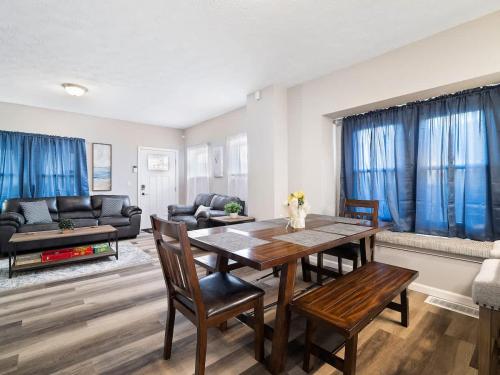 a living room with a wooden table and chairs at Large Remodeled 4 Bedroom Only 7 Minutes to Downtown in Cleveland