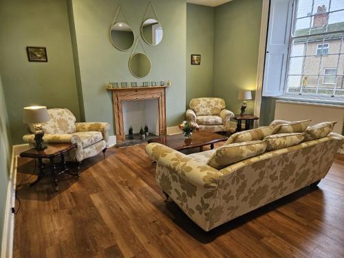 a living room with two couches and a fireplace at The White House Hotel in Williton