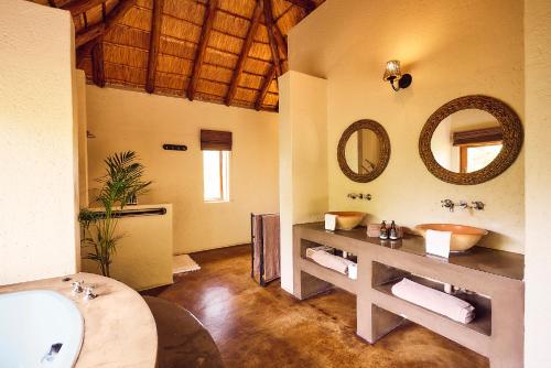 a bathroom with a sink and a mirror at Parsons House in Hoedspruit