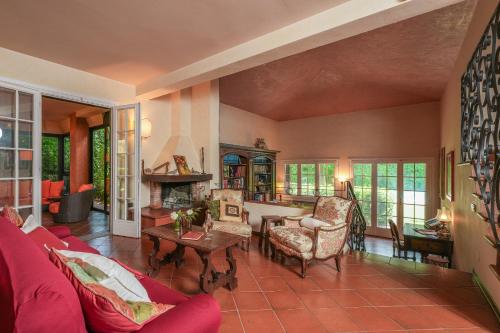 a living room with a red couch and a table at Villa Monica in Le Bolle