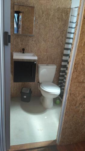 a bathroom with a toilet and a sink and stairs at El Refugio in Santa Vitória do Palmar