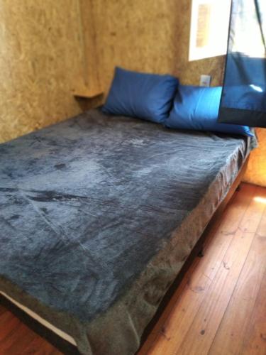 a large bed in a room with a wooden floor at El Refugio in Santa Vitória do Palmar