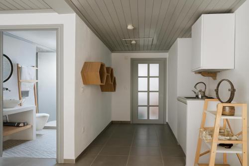 a bathroom with white walls and a ceiling at Keresbino Hydra Port House in Hydra