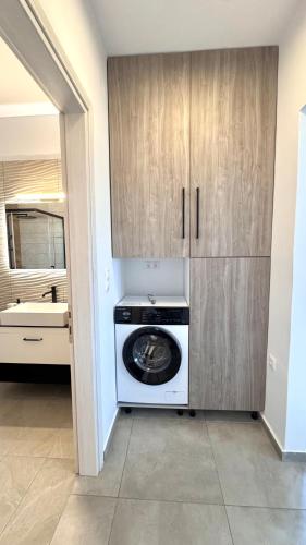 a kitchen with a washer and dryer in a room at Aroniadika rooms in Kythira