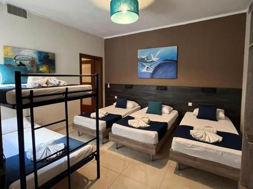 a room with four bunk beds in it at Belle Apartments in St. Julianʼs