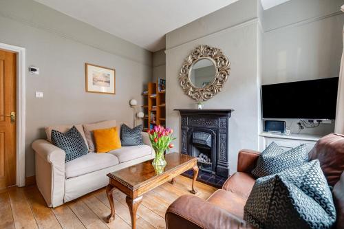 a living room with two couches and a fireplace at Gamul Place - Quiet City Centre in Chester