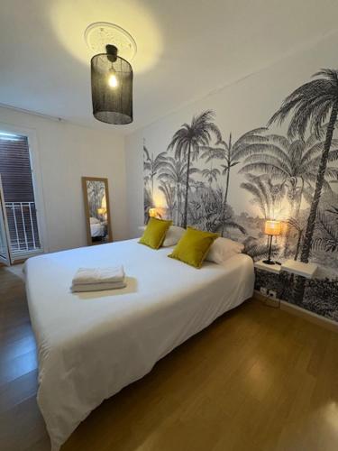 a bedroom with a large white bed with yellow pillows at BLEU CASSIS-VINTAGE -3 Ch- Magnifique vue mer- Parking gratuit et Jardin in Cassis