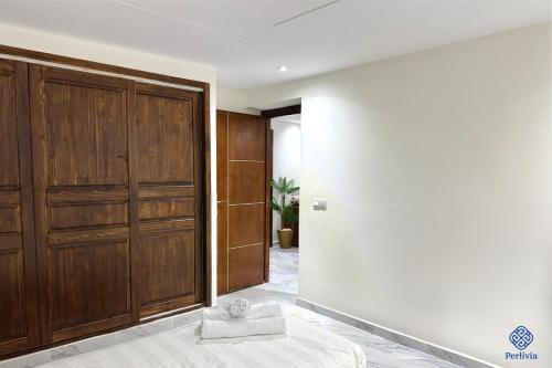 a room with a large wooden closet and a bed at Perlivia in Chefchaouen