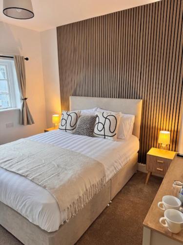 a bedroom with a bed with two pillows on it at The Wrey Arms in Barnstaple