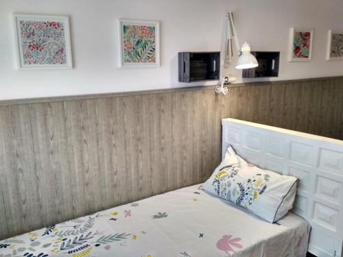 a bedroom with a bed with a white headboard at Casona MilaWen in Potes