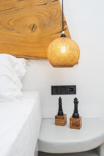 a bedroom with a bed with a wooden ceiling and a lamp at Olive Garden Hotel in Agios Prokopios