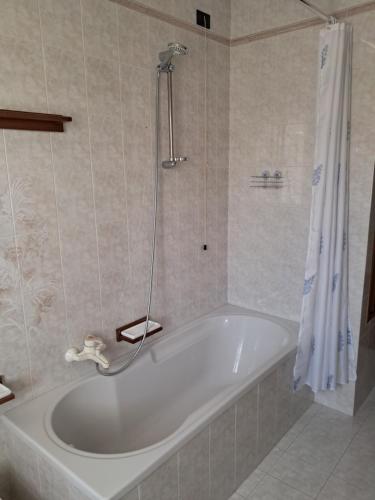 a white bath tub in a bathroom with a shower at Casa Maria in Valmareno