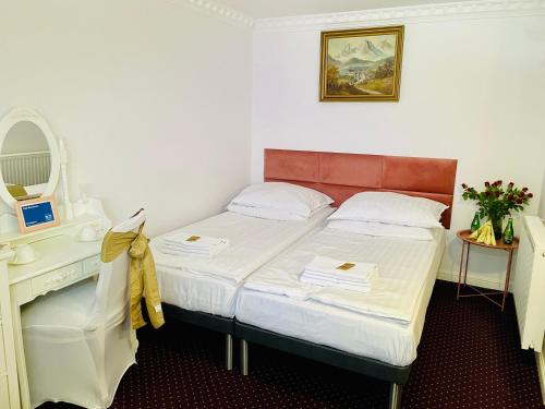 a small bedroom with a bed and a desk at K&B Residence in Jarosław