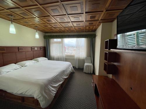 En eller flere senge i et værelse på Hotel Zeus