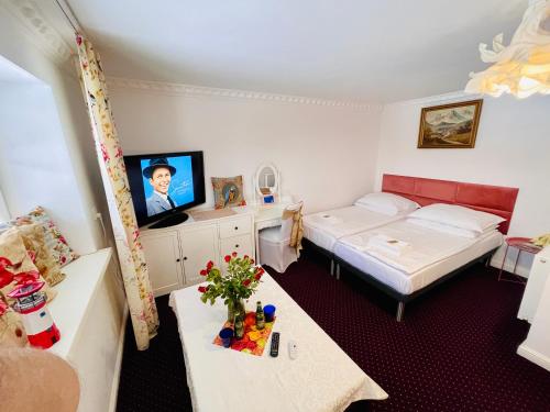 a small room with a bed and a tv at K&B Residence in Jarosław