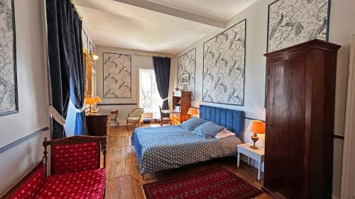 a living room with a bed and a couch in it at Château de la Chabroulie in Isle